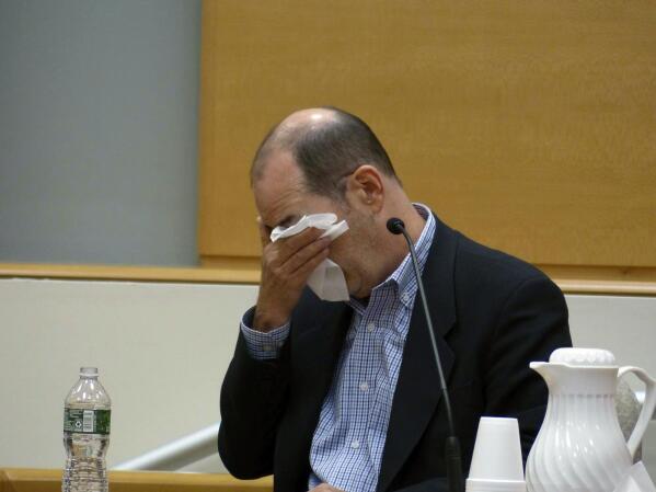 David Wheeler, father of Benjamin Wheeler, stops to wipe tears away as he testifies during the Alex Jones Sandy Hook defamation damages trial at Connecticut Superior Court in Waterbury, Conn., Wednesday, Sept. 21, 2022. (Christian Abraham/Hearst Connecticut Media via AP)