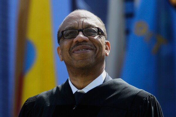 Eugene Robinson, Pulitzer Prize-winning journalist and author, smiles while receiving the honorary Doctor of Humane Letters at the University of Michigan commencement at Michigan Stadium in Ann Arbor, Mich., Saturday, April 30, 2011. (AP Photo/Paul Sancya, File)