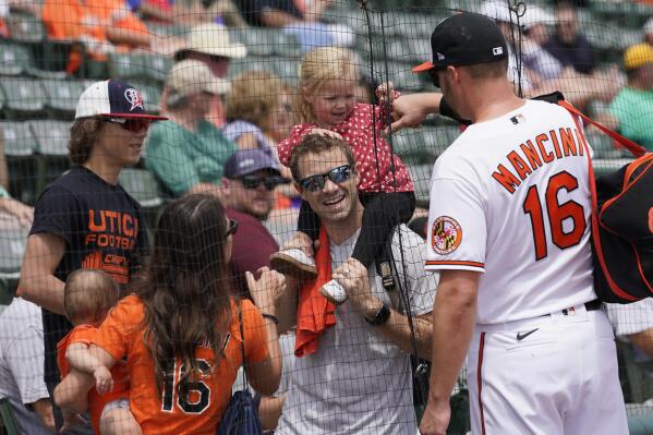 Baltimore Orioles designated hitter Trey Mancini (16) talks with fans prior to the start of a spring training baseball game against the Philadelphia Phillies at Ed Smith Stadium Friday, April 1, 2022, in Sarasota, Fla. (AP Photo/Steve Helber)