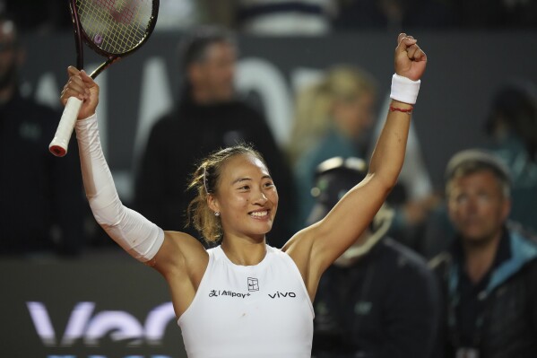 China's Qinwen Zheng celebrates after winning a quarter-final tennis match against Aryna Sabalenka of Belarus at the Italian Open in Rome, Italy, Wednesday, May 14, 2025. (AP Photo/Alessandra Tarantino)