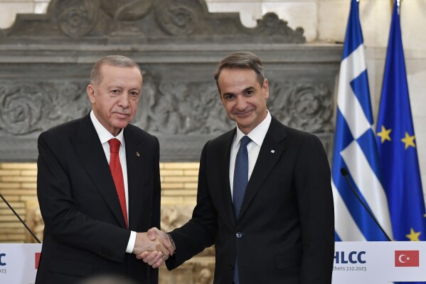Greece's Prime Minister Kyriakos Mitsotakis, right, shakes hands with Turkey's President Recep Tayyip Erdogan after their statements at Maximos Mansion in Athens, Greece, Thursday, Dec. 7, 2023. Turkish President Recep Tayyip Erdogan is visiting Greece in an effort to mend strained relations and reset ties with Western allies. (AP Photo/Michael Varaklas)