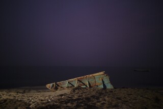 FILE - The wreck of a traditional Mauritanian fishing boat, known as a pirogue, also used by migrants to reach Spain's Canary Islands, sits on a beach near Nouadhibou, Mauritania, Dec. 2, 2021. Four migrants were found dead and 64 were rescued when a boat from Mauritania reached Spain's Canary Islands after a dangerous Atlantic journey from West Africa, Spain's Maritime Rescue Service said. The migrants arrived on the island of El Hierro late on March 5 2024 evening, with the survivors including two women and nine minors, the service said. (AP Photo/Felipe Dana, File)