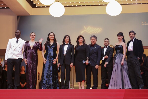 Jury president Greta Gerwig, second form left, poses with jury members Omar Sy, from left, Lily Gladstone, Nadine Labaki, Ebru Ceylan, Kore-eda Hirokazu, J.A. Bayona, Eva Green, and Pierfrancesco Favino upon arrival at the awards ceremony and the premiere of the film 'The Second Act' during the 77th international film festival, Cannes, southern France, Tuesday, May 14, 2024. (Photo by Vianney Le Caer/Invision/AP)