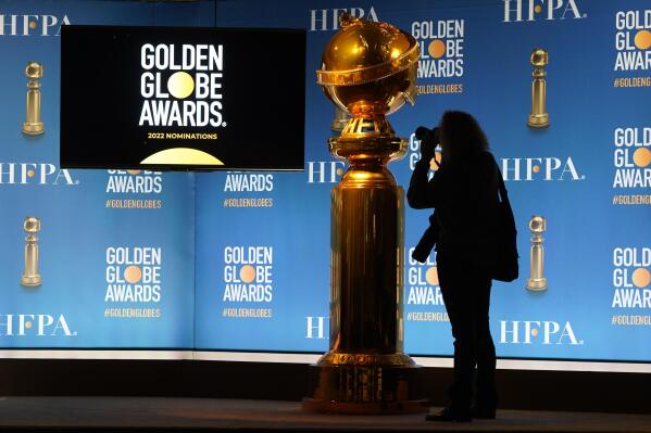 A photographer shoots a Golden Globe statue at the nominations event for 79th annual Golden Globe Awards at the Beverly Hilton Hotel on Monday, Dec. 13, 2021, in Beverly Hills, Calif. The 79th annual Golden Globe Awards will be held on Sunday, Jan. 9, 2022. (AP Photo/Chris Pizzello)