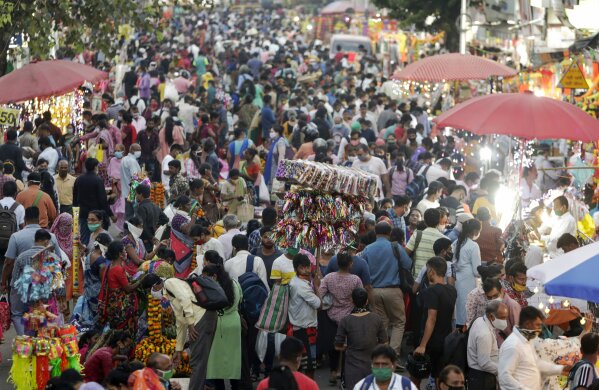 People crowd a market place for Diwali festival shopping in Mumbai, India, Thursday, Nov. 12, 2020. India's tally of coronavirus cases is currently the second largest in the world behind the United States. The government warns that the situation can worsen due to people crowding markets for festival shopping. (AP Photo/Rajanish Kakade)