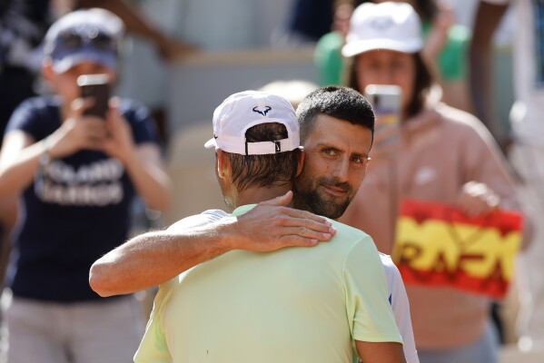 Serbia's Novak Djokovic greets Spain's Rafael Nadal after Nadal's training session at the Roland Garros stadium, Saturday, May 25, 2024 in Paris. The French Open tennis tournament starts Sunday May 26, 2024. (AP Photo/Jean-Francois Badias)