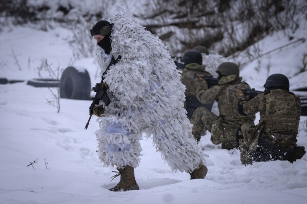 Members of the pro-Ukrainian Russian ethnic Siberian Battalion practice at a military training close to Kyiv, Ukraine, Wednesday, Dec. 13, 2023. Ukraine's military has formed a battalion of soldiers made up entirely of Russian citizens who want to fight against Russian invasion.(AP Photo/Efrem Lukatsky)