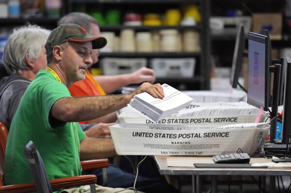 FILE - Allegheny County workers scan mail-in and absentee ballots at the Allegheny County Election Division Elections warehouse in Pittsburgh, Nov. 3, 2022. Mail-in ballots in Pennsylvania without accurate handwritten dates on their exterior envelopes must still be counted if they are received in time, a judge ruled Tuesday, Nov. 21, 2023, concluding that rejecting such ballots violates federal civil rights law. (AP Photo/Gene J. Puskar, File)