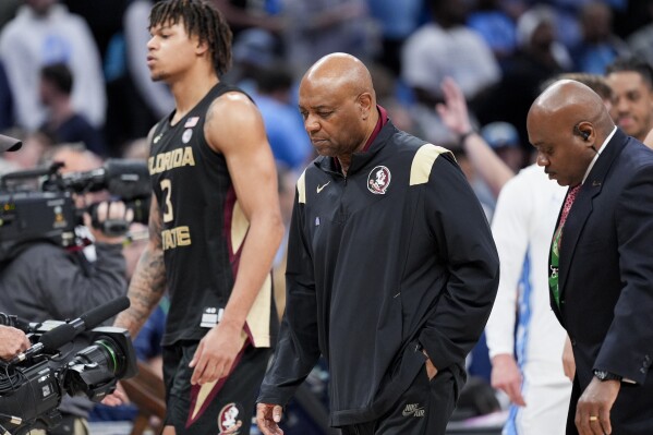 Florida State forward Cam Corhen (3) and head coach Leonard Hamilton leave the court following of an NCAA college basketball game against North Carolina in the quarterfinal round of the Atlantic Coast Conference tournament, Thursday, March 14, 2024, in Washington. (AP Photo/Susan Walsh)