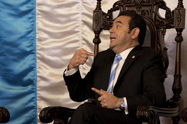 FILE - In this Jan. 10, 2019 file photo, then Guatemalan President Jimmy Morales talks with Canada's ambassador Rita Marija Rudaitis-Renaud during a welcome ceremony for ambassadors in Guatemala City. Guatemalan prosecutors on Wednesday, April 21, 2021, have requested that former President Morales be stripped of his immunity so he can be prosecuted for violating the mandate of the United Nations backed anti-corruption mission then working in the country. (AP Photo/Moises Castillo, File)