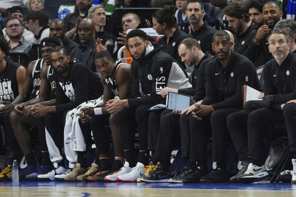 Brooklyn Nets guard Ben Simmons, center, sits on the bench during the second half of the team's NBA basketball game against the Minnesota Timberwolves, Saturday, Feb. 24, 2024, in Minneapolis. (AP Photo/Abbie Parr)
