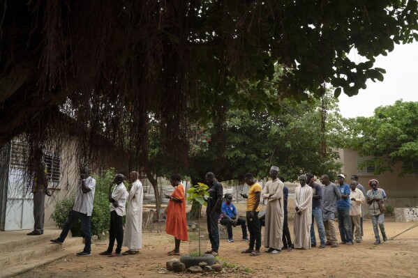 People line up to cast their ballot for legislative elections in Dakar, Senegal, Sunday, July 31, 2022. (AP Photo/Leo Correa)