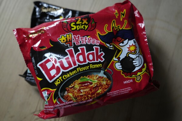 In this photo illustration two packets of Samyang noodles are pictured in London, Wednesday, June 12, 2024. Food authorities in Denmark have recalled three types of spicy instant noodle products imported from South Korea over possible risks for “acute poisoning.” (AP Photo)