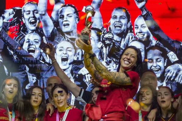 FILE - Spain's Jennifer Hermoso holds the trophy as they celebrate their Women's World Cup victory on stage in Madrid, Spain, Monday, Aug. 21, 2023. Spanish state prosecutors say soccer player Jenni Hermoso has accused Luis Rubiales of sexual assault for kissing her on the lips without her consent after the Women's World Cup final. (AP Photo/Manu Fernandez, File)