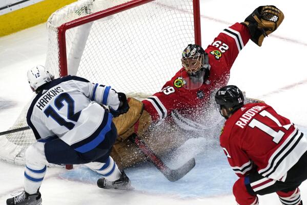 Chicago Blackhawks goaltender Marc-Andre Fleury (29) cannot make the save on a goal by Winnipeg Jets center Jansen Harkins (12) during the second period of an NHL hockey game in Chicago, Sunday, March 20, 2022. (AP Photo/Nam Y. Huh)