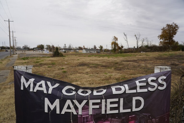 A banner reading "May God Bless Mayfield" hangs near empty lots, Thursday, Nov. 9, 2023, in Mayfield, Ky. (AP Photo/Joshua A. Bickel)