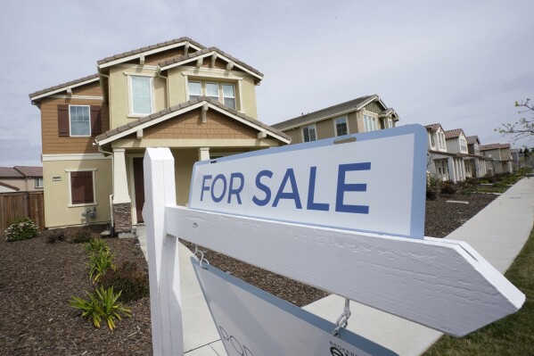 FILE - A "for sale" sign is posted in front of a home in Sacramento, Calif., March 3, 2022. A closely watched housing market barometer shows U.S. home prices in November, 2023, posted their biggest annual gain in more than a year. S&P Dow Jones Indices’ CoreLogic Case-Shiller national home price index rose 5.1% over the 12 months ended in November. (AP Photo/Rich Pedroncelli, File)