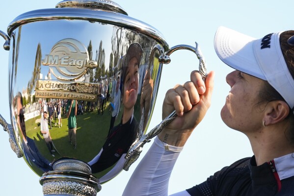 Hannah Green holds up the championship trophy after winning the LPGA's JM Eagle LA Championship golf tournament at Wilshire Country Club, Sunday, April 28, 2024, in Los Angeles. (AP Photo/Ashley Landis)