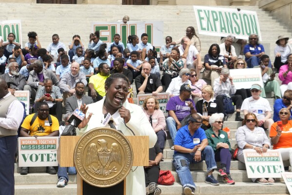 Azia Wiggins, an organizer with Working Together Mississippi, opens the Mississippi Medicaid Expansion Rally at the Mississippi State Capitol in Jackson, with a song, Tuesday, April 16, 2024. (AP Photo/Rogelio V. Solis)