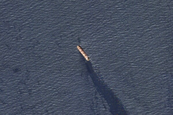In this satellite image provided by Planet Labs, the Belize-flagged bulk carrier Rubymar is seen in the southern Red Sea near the Bay el-Mandeb Strait leaking oil after an attack by Yemen's Houthi rebels Tuesday, Feb. 20, 2024. Despite a month of U.S.-led airstrikes, Yemen's Iran-backed Houthi rebels remain capable of launching significant attacks. This week, they seriously damaged a ship in a crucial strait and apparently downed an American drone worth tens of millions of dollars. (Planet Labs PBC via 麻豆传媒app)