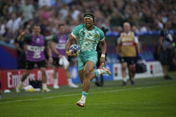 South Africa's Kurt-Lee Arendse runs to scores a try during the Rugby World Cup Pool B match between South Africa and Scotland at the Stade de Marseille in Marseille, France, Sunday, Sept. 10, 2023. (AP Photo/Daniel Cole)