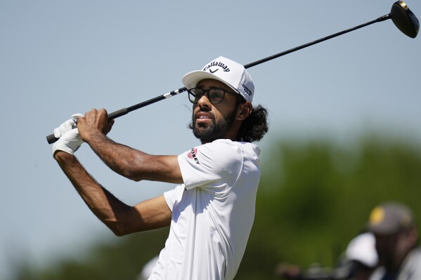 Akshay Bhatia watches his tee shot on the fourth hole during the first round of the Texas Open golf tournament, Thursday, April 4, 2024, in San Antonio. (AP Photo/Eric Gay)