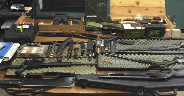 FILE - This undated photo provided by the Van Buren County Sheriff's Office in Paw Paw, Mich., shows stolen guns, ammunition and knives that were recovered Sept. 12, 2015, in Antwerp Township, Mich. The rate of guns stolen from cars in the U.S. has tripled over the last decade, making them the largest source of stolen guns in the country, a new analysis of FBI data by the gun-safety group Everytown found. (Van Buren County Sheriff's Office via AP)