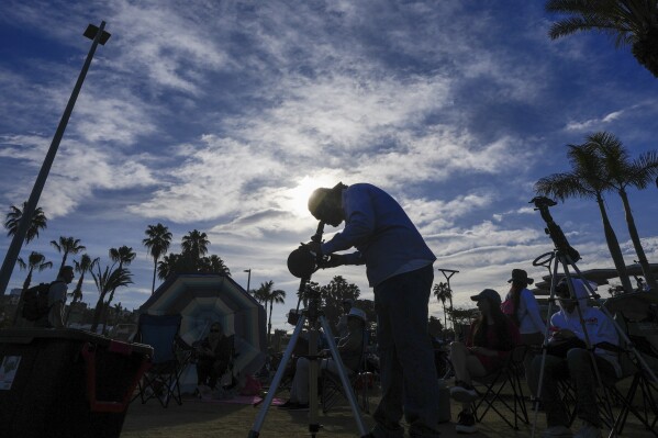 Amateur astronomers prepare to watch a total solar eclipse in Mazatlan, Mexico, Monday, April 8, 2024. (AP Photo/Fernando Llano)