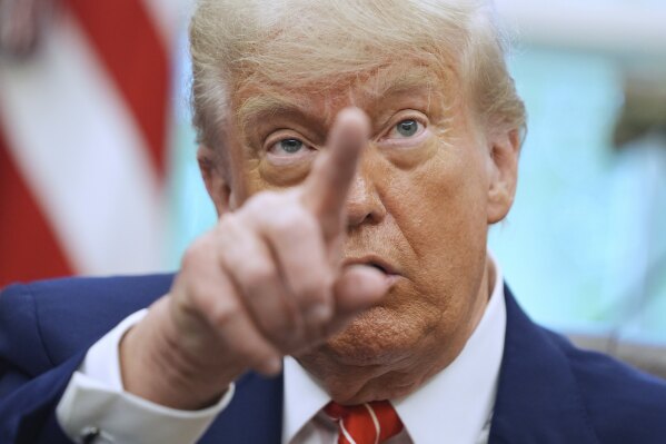 President Donald Trump gestures as he speaks with reporters in the Oval Office of the White House, May 8, 2025, in Washington. (AP Photo/Evan Vucci, FIle)