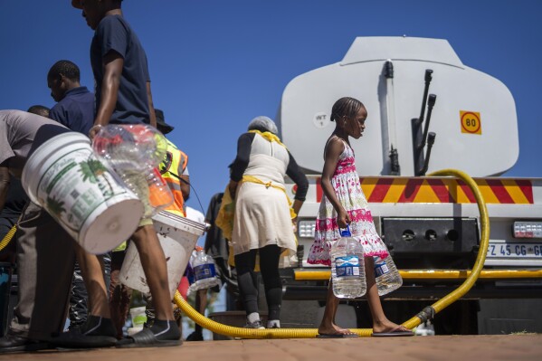 Residents of the township of Soweto, South Africa, queue for water March 16, 2024. (AP Photo/Jerome Delay)