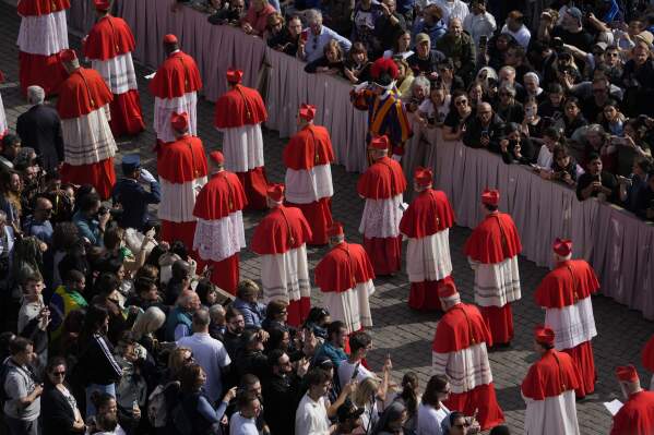 Cardinals take part in the ceremony transfering Pope Francis' body, who will lie in state at St. Peter's Basilica for three days, at the Vatican, Wednesday, April 23, 2025. (AP Photo/Gregorio Borgia)