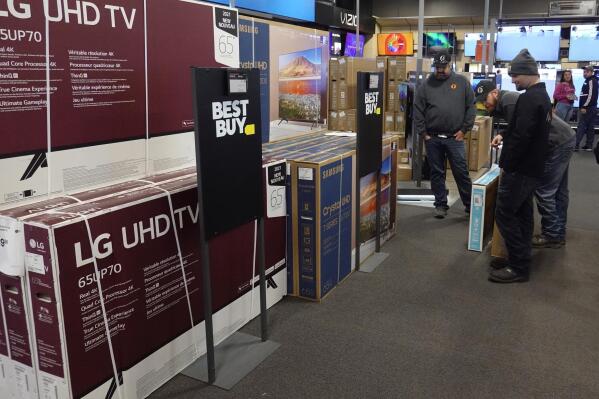 FILE - Customers debate on a television selection during a Black Friday sale at Best Buy, Friday, Nov. 26, 2021, in Indianapolis.  U.S. consumer prices rose 5.7% over the past year, the fastest pace in 39 years as a surge in inflation battered Americans as the holiday shopping season was getting under way.  (AP Photo/Darron Cummings, File)