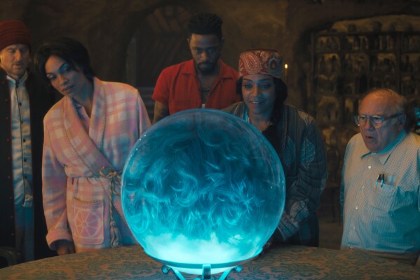 This image released by Disney Enterprises shows, from left, Owen Wilson, Rosario Dawson, LaKeith Stanfield, Tiffany Haddish and Danny DeVito in a scene from "Haunted Mansion." (Disney Enterprises via AP)