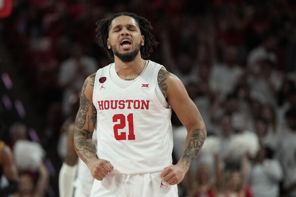 Houston guard Emanuel Sharp (21) celebrates after hitting a 3-pointer and drawing a foul during the first half of an NCAA college basketball game against Louisiana-Monroe, Monday, Nov. 6, 2023, in Houston. (AP Photo/Kevin M. Cox)