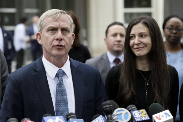 FILE - This June 19, 2019 file photo shows U.S. Attorney Richard Donoghue, left, talking to the media with prosecutor Moira Penza outside Brooklyn federal court after NXIVM defendant Keith Raniere was found guilty on all counts, in New York. A judge has set an Oct. 27, 2020 sentencing date for Raniere, leader of an upstate New York self-improvement group who was convicted last year on charges that he turned some of followers into sex slaves. (AP Photo/Mark Lennihan, File)