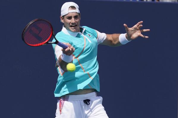 John Isner, of the United States, returns the ball to Hugo Gaston, of France, during the Miami Open tennis tournament, Friday, March 25, 2022, in Miami Gardens, Fla. (AP Photo/Marta Lavandier)