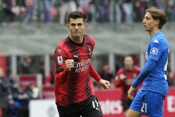 AC Milan's Christian Pulisic celebrates after scoring his side's opening goal during a Serie A soccer match between AC Milan and Empoli at the San Siro stadium in Milan, Italy, Sunday, March 10, 2024. (AP Photo/Luca Bruno)