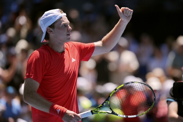 Alex Michelsen of the U.S. reacts after defeating Stefanos Tsitsipas of Greece in their first round match at the Australian Open tennis championship in Melbourne, Australia, Monday, Jan. 13, 2025. (AP Photo/Ng Han Guan)