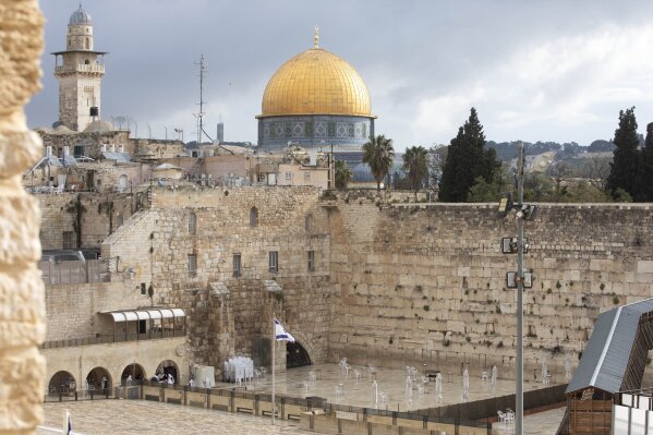 The Dome of the Rock Mosque in the Al Aqsa Mosque compound, and the Western Wall, the holiest site where Jews can pray, are seen in Jerusalem's Old City, Friday, April 10, 2020.  Christians are commemorating Jesus' crucifixion without the solemn church services or emotional processions of past years, marking Good Friday in a world locked down by the coronavirus pandemic. (AP Photo/Sebastian Scheiner)