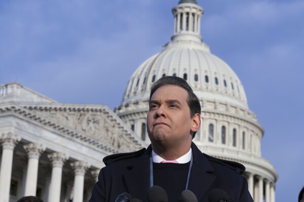 Rep. George Santos, R-N.Y., faces reporters at the Capitol in Washington, early Thursday, Nov. 30, 2023. After a scathing report by the House Ethics Committee citing egregious violations, Santos could be expelled from Congress this week. (AP Photo/J. Scott Applewhite)