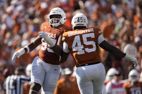 Texas defensive lineman Alfred Collins (95) and defensive lineman Vernon Broughton (45) celebrate a play against Rice during the second half of an NCAA college football game in Austin, Texas, Saturday, Sept. 2, 2023. (AP Photo/Eric Gay)