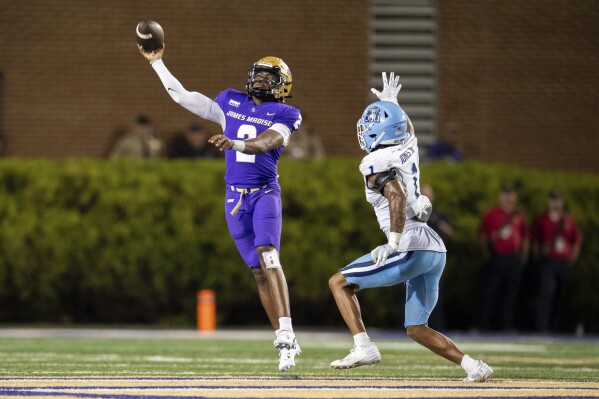 James Madison quarterback Jordan McCloud (2) throws a pass as he is pressured by Old Dominion safety Terry Jones (1) during the first half of an NCAA college football game Saturday, Oct. 28, 2023, in Harrisonburg, Va. (AP Photo/Mike Caudill)