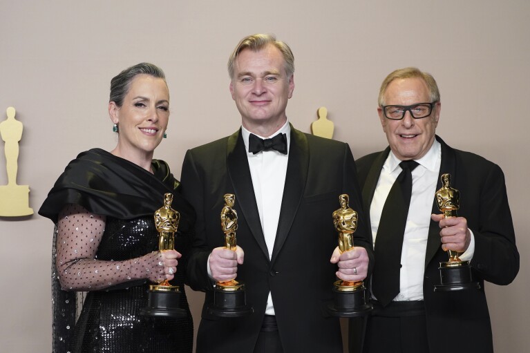 Emma Thomas, from left, Christopher Nolan, and Charles Roven pose in the press room with the award for best picture for "Oppenheimer" at the Oscars on Sunday, March 10, 2024, at the Dolby Theatre in Los Angeles. (Photo by Jordan Strauss/Invision/AP)