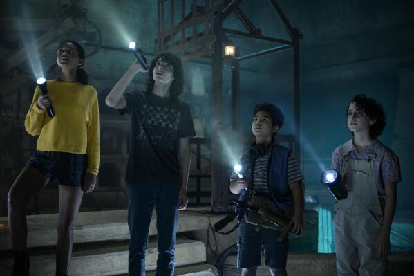 This image released by Sony Pictures shows, Celeste O'Connor, from left, Finn Wolfhard, Logan Kim and McKenna Grace in a scene from "Ghostbusters: Afterlife. (Kimberley French/Sony Pictures via AP)