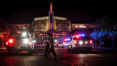 Movie-goers evacuate the Century Rio movie theater as officers respond to a shooting at the theater located at 4901 Pan American freeway in northeast Albuquerque, N.M., on Sunday, June 25, 2023. The Albuquerque Police Department said Monday that an argument over seat reservations escalated into a shooting that left a 52-year-old man dead and sent filmgoers scrambling for cover. Homicide charges were filed Monday against a 19-year-old who was wounded in the Sunday-night confrontation. (Chancey Bush/The Albuquerque Journal via AP)
