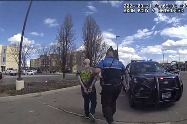 In this photo made from body camera footage and released by the Twin Falls, Idaho, Police Department, Skylar Meade, left, is arrested in Twin Falls on Thursday, March 21, 2024. Police said Meade, an Idaho prison inmate, escaped from custody when an accomplice ambushed corrections officers who were preparing to transport him back to prison from a hospital in Boise on Wednesday, March 20. Authorities say Meade and his accomplice, Nicholas Umphenour, may have been responsible for the killings of two men in northern Idaho while on the run. (Twin Falls Police Department via AP)