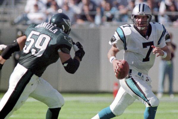 FILE - Carolina Panthers quarterback Steve Beuerlein (7) eludes Philadelphia Eagles' Mike Mamula (59) in the third quarter of an NFL football game at Ericsson Stadium in Charlotte, N.C., Sunday, Nov. 7, 1999. Mamula was among the first players to train specifically for the staple of tests he'd face at the NFL combine: the 40-yard dash that calibrates speed, the three-cone drill that calculates agility and the 225-pound bench press that gauges strength and stamina. (AP Photo/Rick Havner, File)