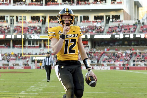 Missouri quarterback Brady Cook react after running for a touchdown against Arkansas during the first half of an NCAA college football game Friday, Nov. 24, 2023, in Fayetteville, Ark. (AP Photo/Michael Woods)
