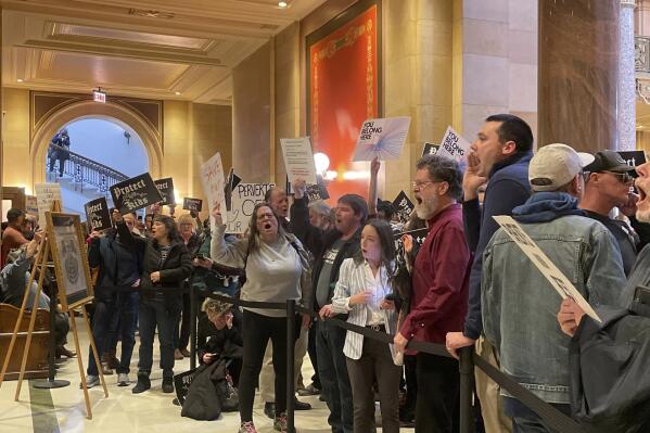 Dozens of protesters chanted for and against a bill that would make Minnesota a trans refuge state, bucking a national trend that's targeting nearly every facet of transgender existence, outside the room where lawmakers would vote on the bill at the state capitol, Thursday, March 23, 2023, in St. Paul, Minn. (AP Photo/Trisha Ahmed)