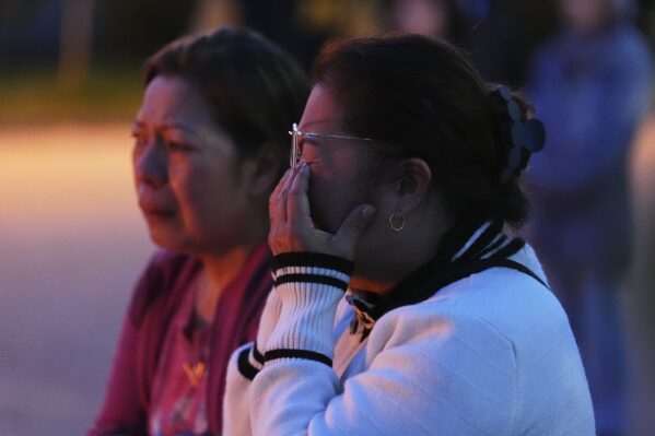 Liza Ahyeng wipes away tears at a memorial for victims after a vehicle drove into a crowd during a Filipino heritage festival in Vancouver, British Columbia, Sunday, April 27, 2025. (AP Photo/Lindsey Wasson)